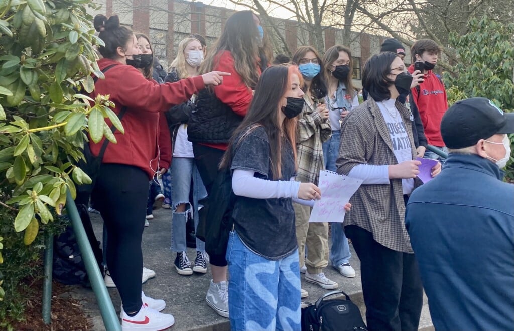 Students at Peninsula High School make a counter-protest to students across the school’s driveway who were protesting the state school mask mandate.
