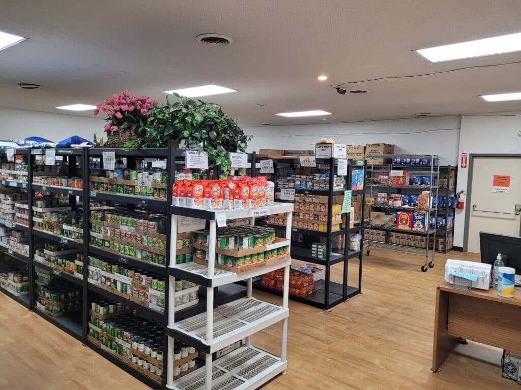 Shelves filled with food line the cramped shopping area at the old Gig Harbor Peninsula FISH Food Bank building.