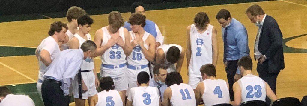 The Gig Harbor Tides boys basketball team huddles up during a time out at the Class 3A state tournament in Gig Harbor on Thursday. The Tides fell to Rainier Beach, 64-60.
