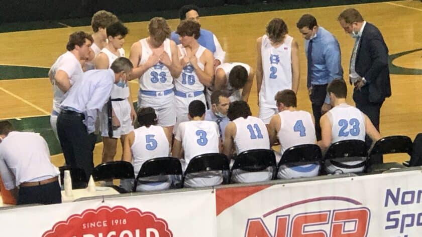 Gig Harbor players and coaches huddle during a break in the action on Thursday, March 3.