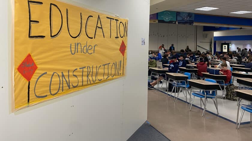 Students eat lunch in the cafeteria of Kopachuck Middle School on Thursday, March 10, 2022, with a temporary wall visible in the foreground. The school and Key Peninsula Middle School are being upgraded with funds from the district’s 2019 bond.