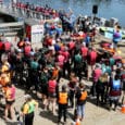 Dragon Boat teams line up for their heat as paddlers from a previous heat exit the dock.