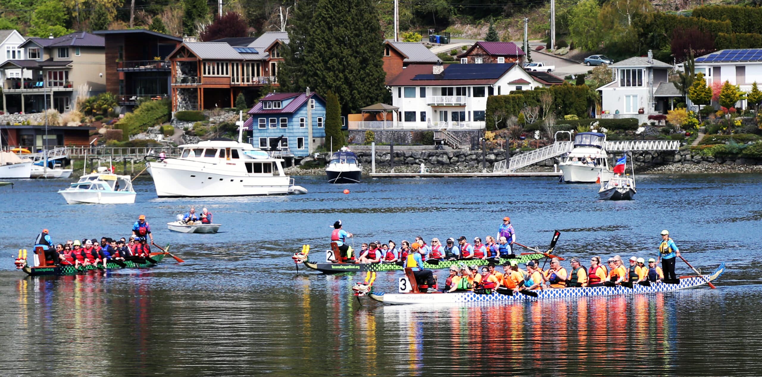 Dragon Boat teams return to the docks after a heat during the 2022 Paddlers Cup on Sunday, April 24, at SKansie Park in Gig Harbor.