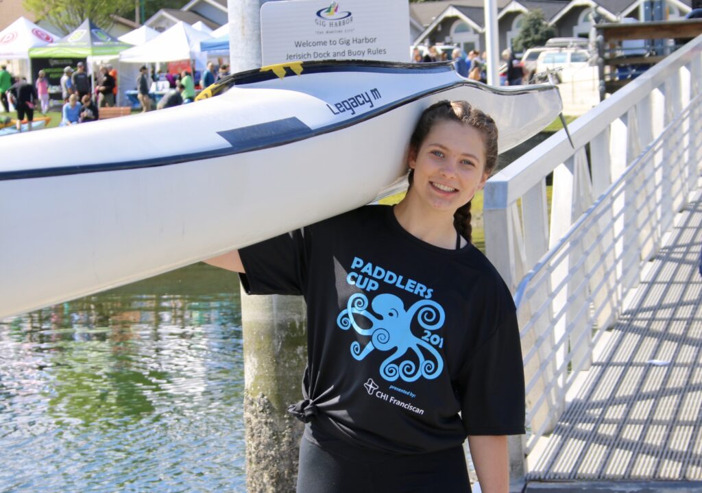 A partipant in the 2019 Paddlers Cup carries her craft.