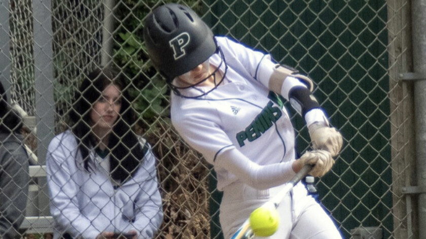 Glory Eastabrook, turns on a ball with perfect technique, for a hit in the 6-0 win as Pitcher Alli Kimball watches from the dugout.