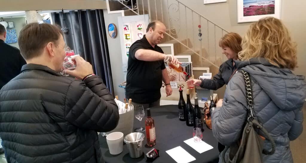 Pouring wine at Ebb Tide Gallery on Pioneer Way in Gig Harbor during the 2020 Winter Sip & Stroll. The sipping and strolling returns for the first time post-pandemic on Saturday, April 30.