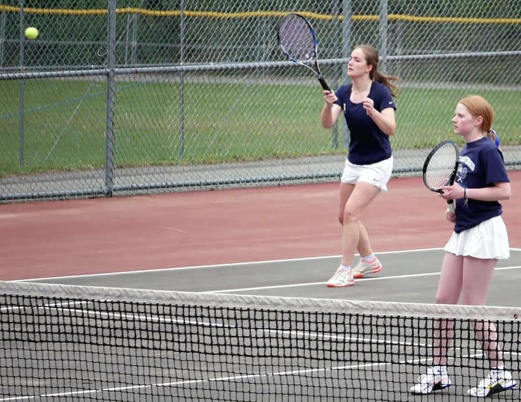 Georgia Pilati returns serve as partner Abbi Brandt looks on. The third doubles team secured the SSC crown by winning 6-1, 6-3 over Yelm.