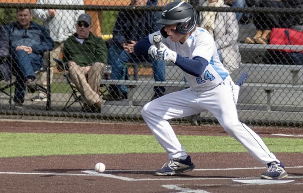 The Tides' Brady Altman lays down a bunt and sprints to first base.