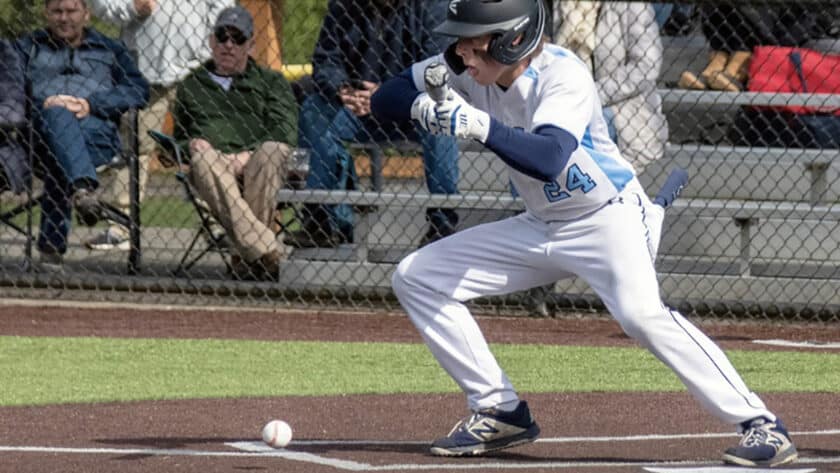 The Tides' Brady Altman lays down a bunt and sprints to first base.