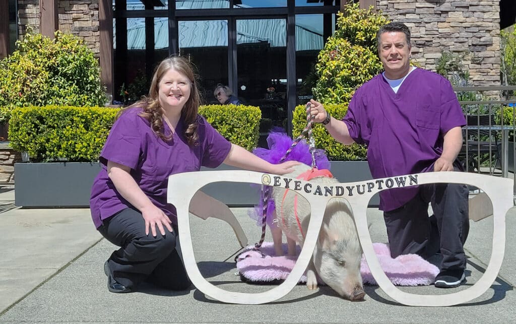 Dr. Kandi Moller, Robert Loehr and Gumdrop outside Eye Candy Optical in the Uptown Gig Harbor shopping complex.