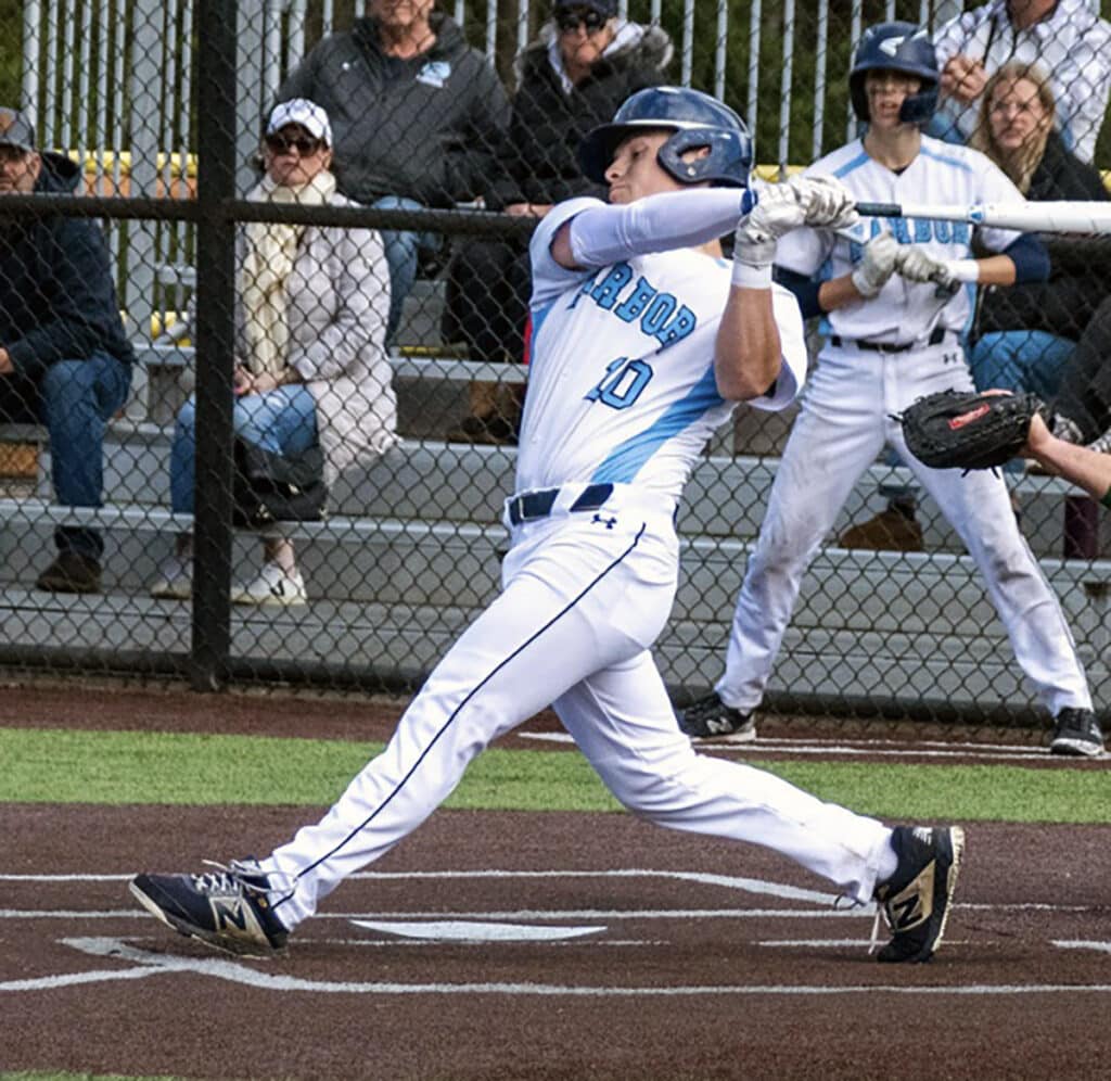 Josh Dunham of the Tides drives a pitch deep to the gap for one of his two doubles.