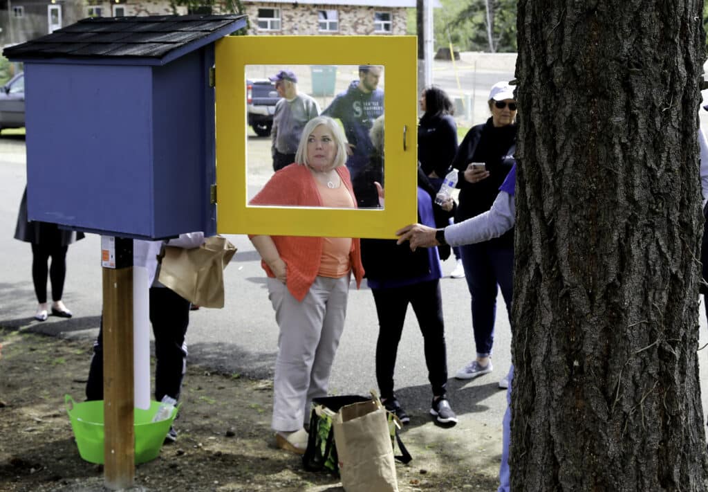 Rotarians stock the new Little Food Pantry at Peninsula Life Church in Purdy on Friday, April 29.