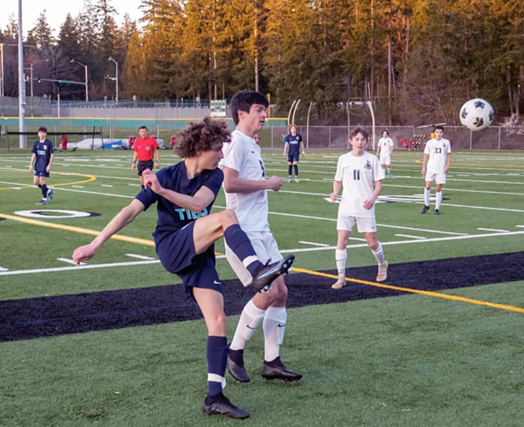 Co leading scorer Reilly Leahy (9) provides pressure to force a pass.