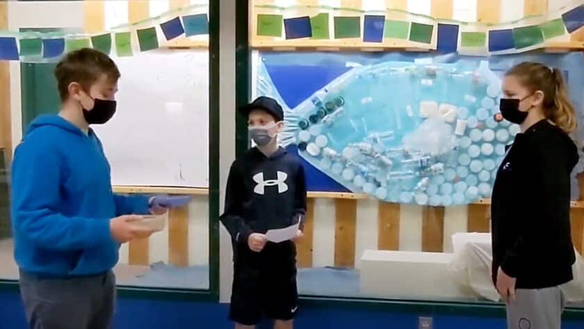 Kopachuck Middle School STEAM Club members Leo Neff, Benton Huish and Elise Hill stand in front of an art installation made of plastic the club collected to show how much waste is generated at the school’s three lunch periods. The students are featured in a video made by their advisor Eileen Schurer that was shown to the Peninsula School District board in April.