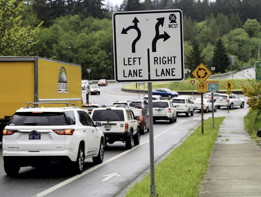 Vehicles wait to enter the roundabout on Borgen Boulevard near the exit to westbound Highway 16 on May 19.