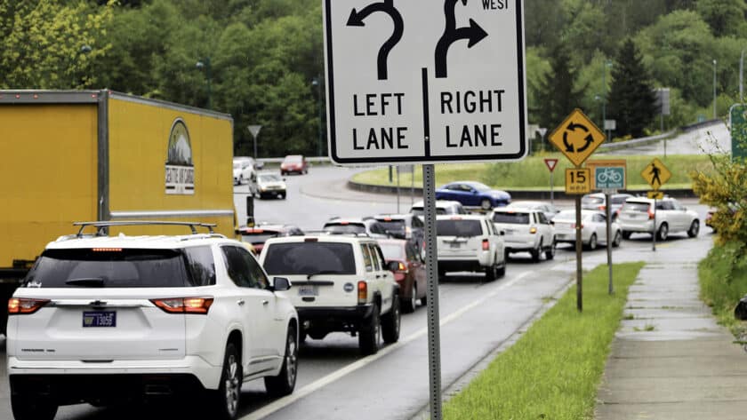 Vehicles wait to enter the roundabout on Borgen Boulevard near the exit to westbound Highway 16 on May 19.