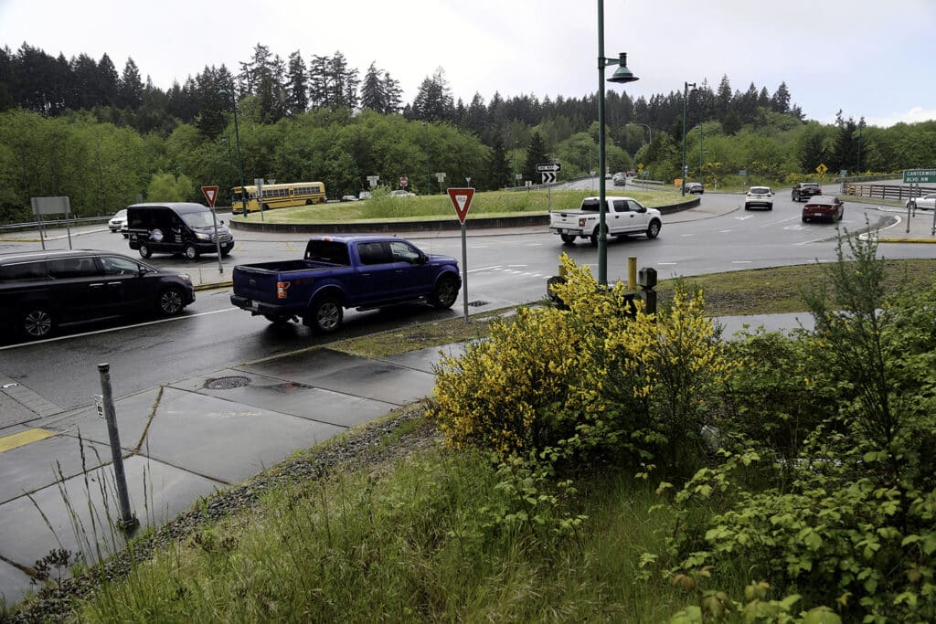 Traffic moves through the roundabout on Borgen Boulevard near the ramp to westbound Highway 16.