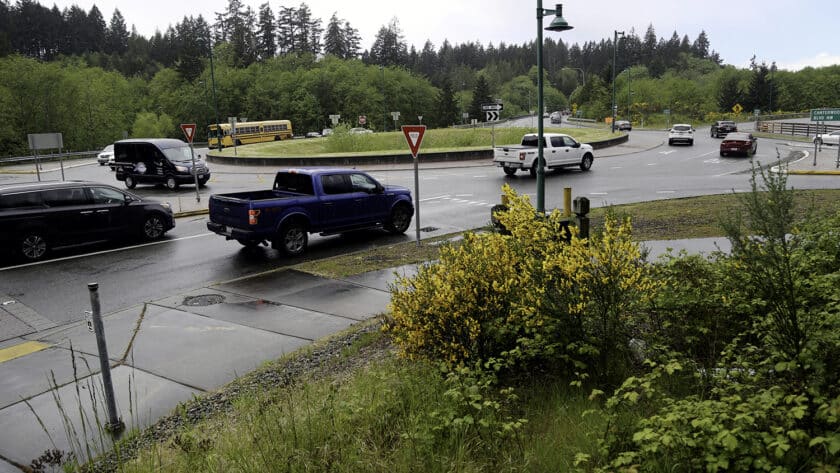 Traffic moves through the roundabout on Borgen Boulevard near the ramp to westbound Highway 16.