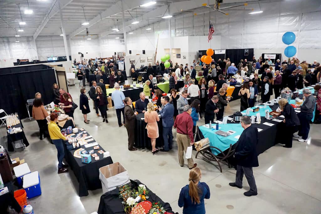 Taste of Gig Harbor attendees peruse auction items during a previous year's event.