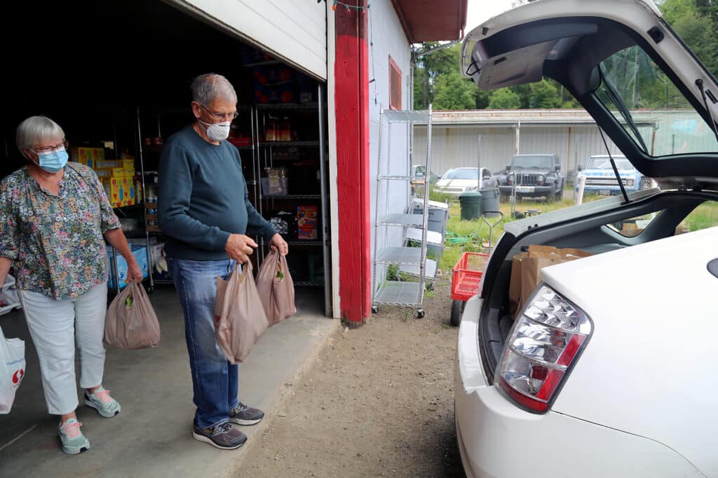 Food Backpacks 4 Kids volunteers load up supplies before delivering food to clients on Wednesday, June 22, 2022.