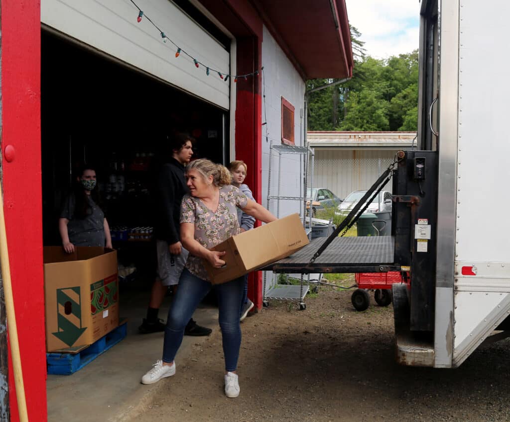 Volunteers unload a delivery at the Food Backpacks 4 Kids Food Pantry on Wednesday, June 22, 2022.