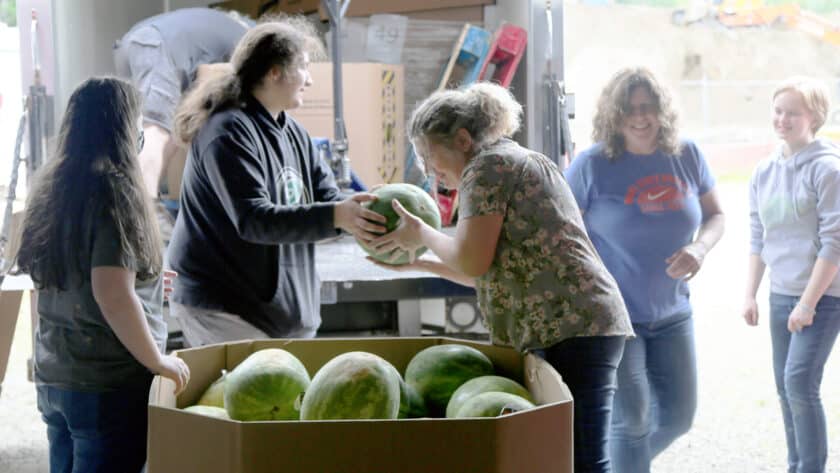 Volunteers unload watermelons delivered to the Food Backpacks 4 Kids Food Pantry on Wednesday, June 22, 2022.