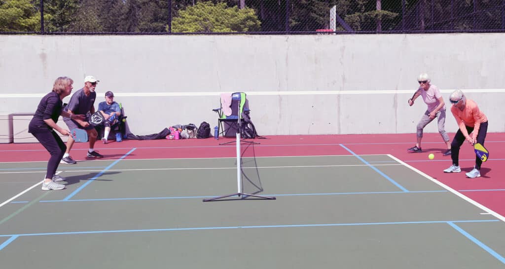 Pickleball is played on a smaller court, allowing more players to participate than in more space-consuming sports like tennis.