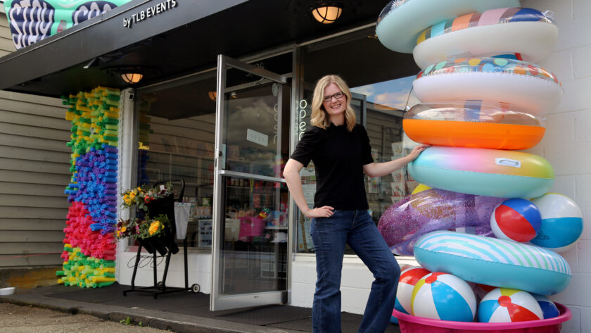 Tammi Barber outside Frills by TLB Events, her store on Harborview Drive in downtown Gig Harbor. Frills features exterior installations, celebrating holidays and seasons. The latest installation, celebrating summer, features colorful pool noodles, beach balls and pool floats.