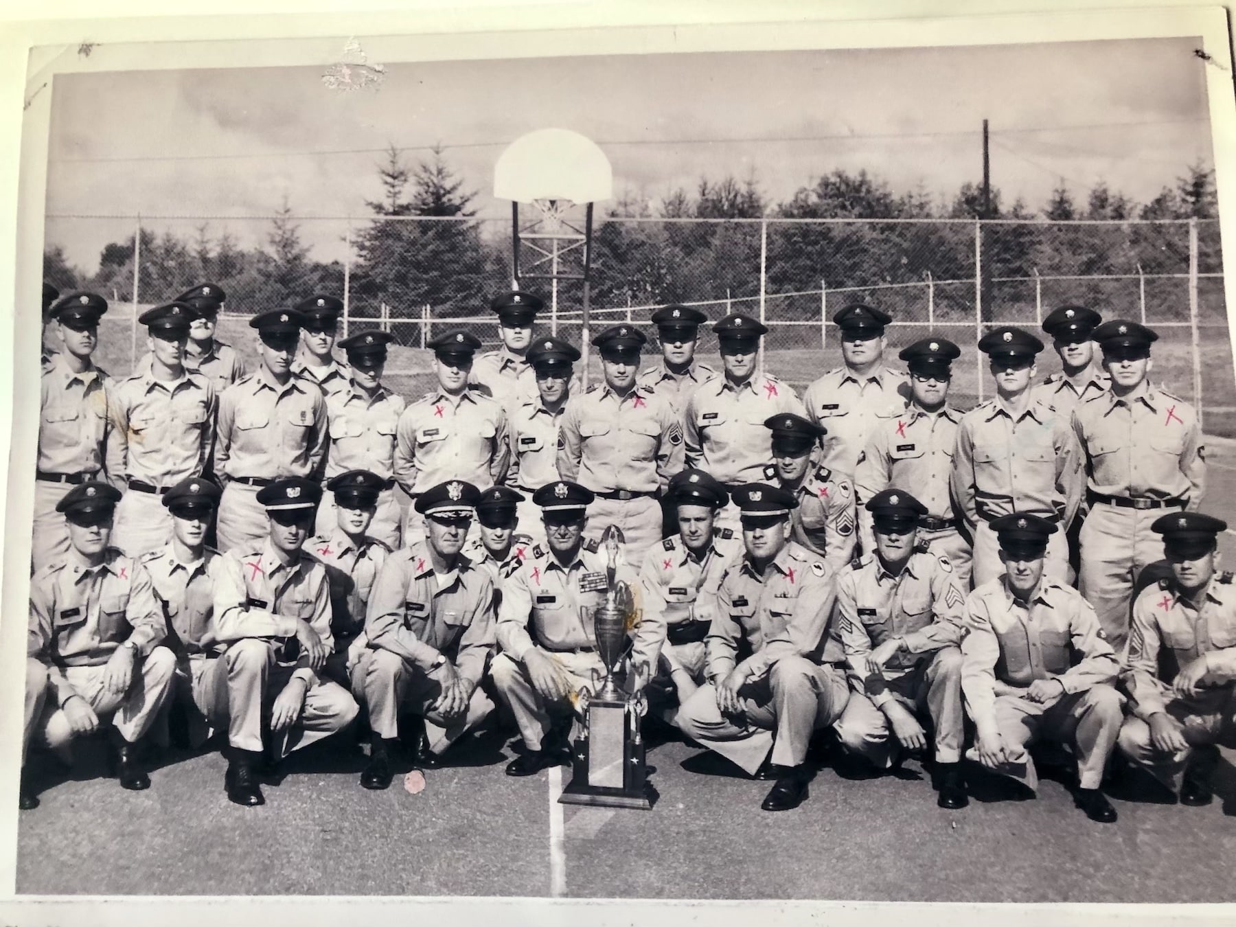 The Olalla Nike team poses with the Commander's Trophy that it won during 1962 firing exercises in New Mexico. Maj. James W. Root is at center, Sgt. Carl Tinker second from left in front and Sgt. Vince Romo 11th from left in back row.