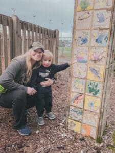 mom and son next to art tiles