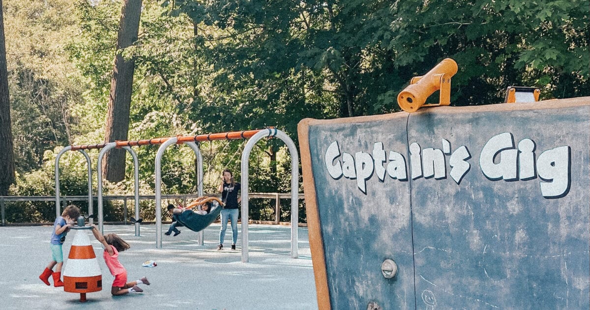 A swingset, boat structure and turn ride are featured at this playgound