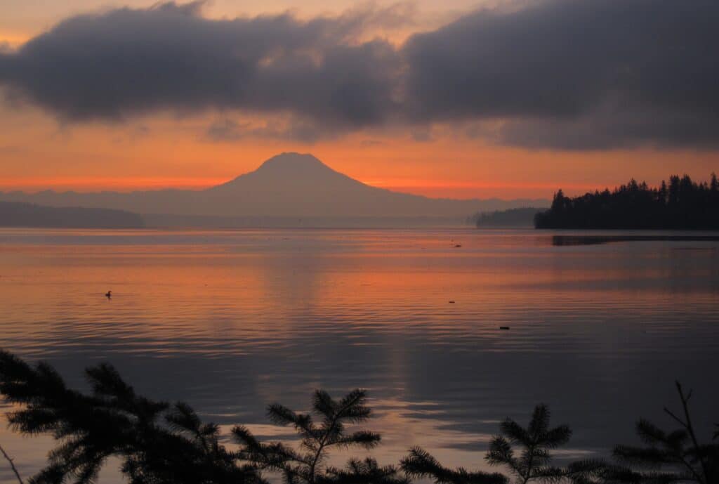 Sunrise behind Mount Rainier and Carr Inlet from Penrose Point State Park.