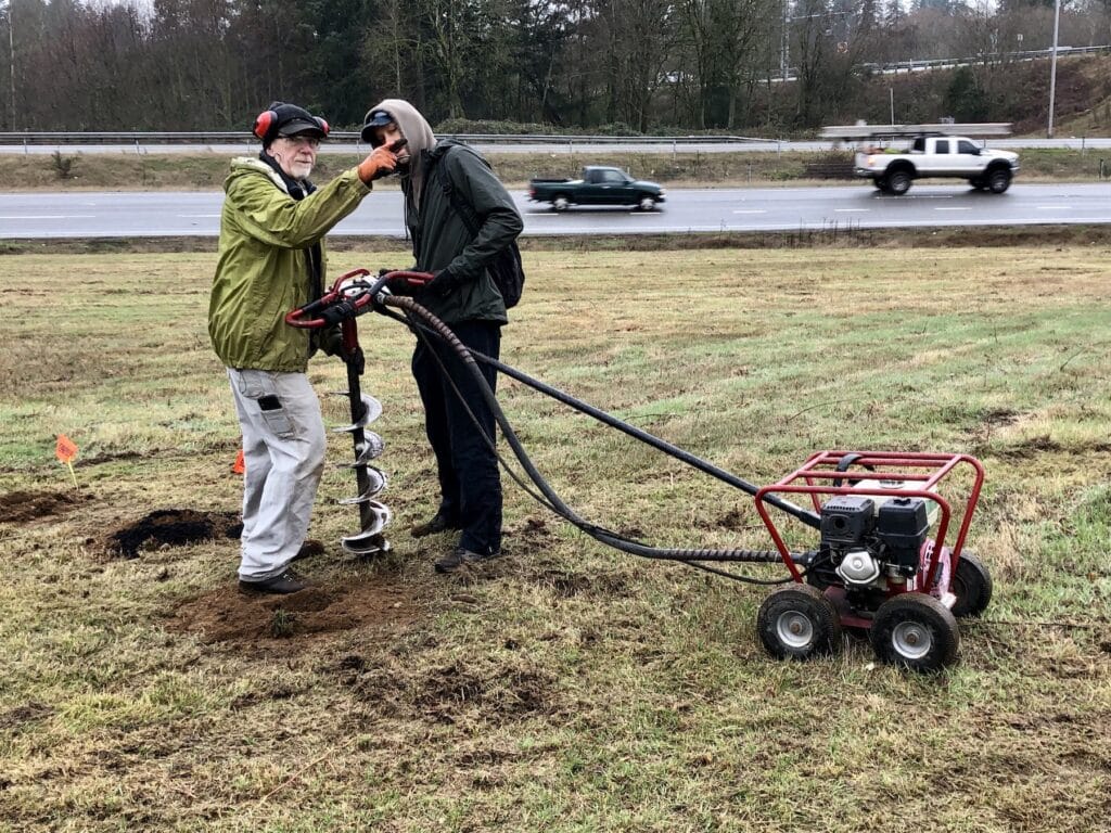 Gary Pellett, left, and Geoff Barcalow dig plant holes Jan. 21 with a power auger.