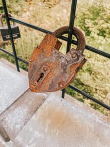 This is an image of a very rusty padlock in the shape of a heart