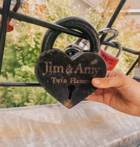 This is a padlock in the shape of a heart with the names "Jim & Amy" on it
