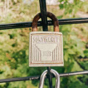 This is an image of a green padlock with art deco lines on it