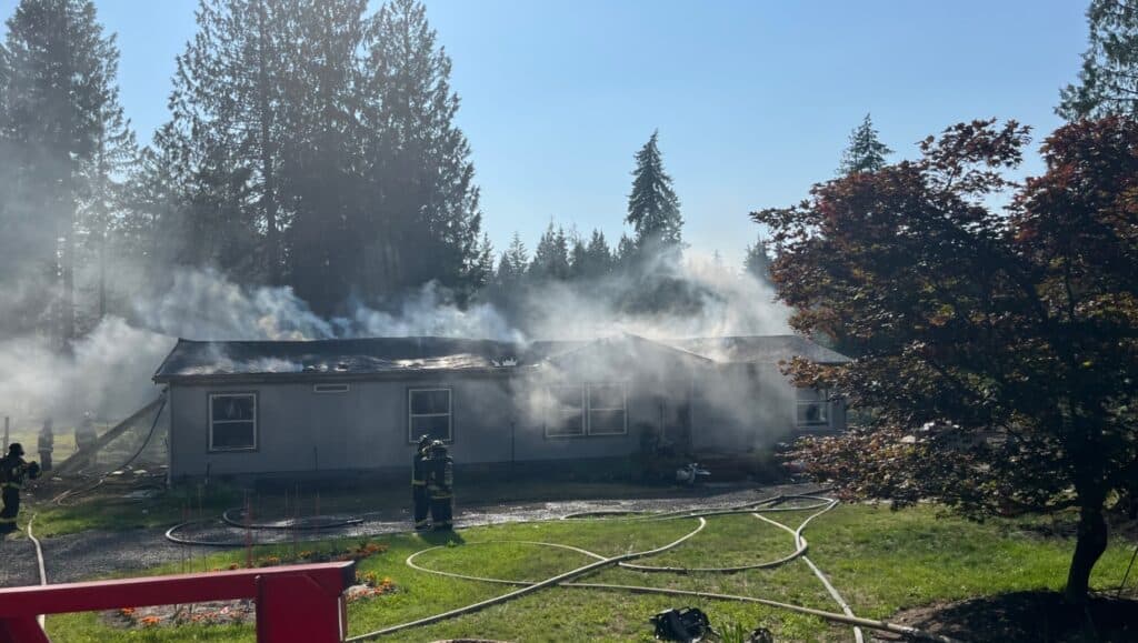 Louise Ross' Peacock Hill Road home smolders after a fire on July 4.