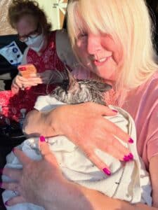 Louise Ross with Remy after firefighters pulled her Maine Coon cat was pulled from the rubble.