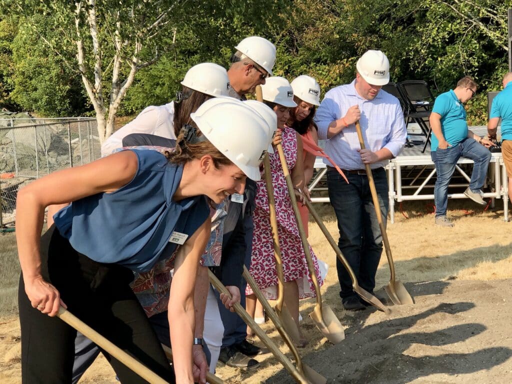 Executive Director Ally Bujacich, in foreground, board members and legislators perform the ritual turning of the dirt.