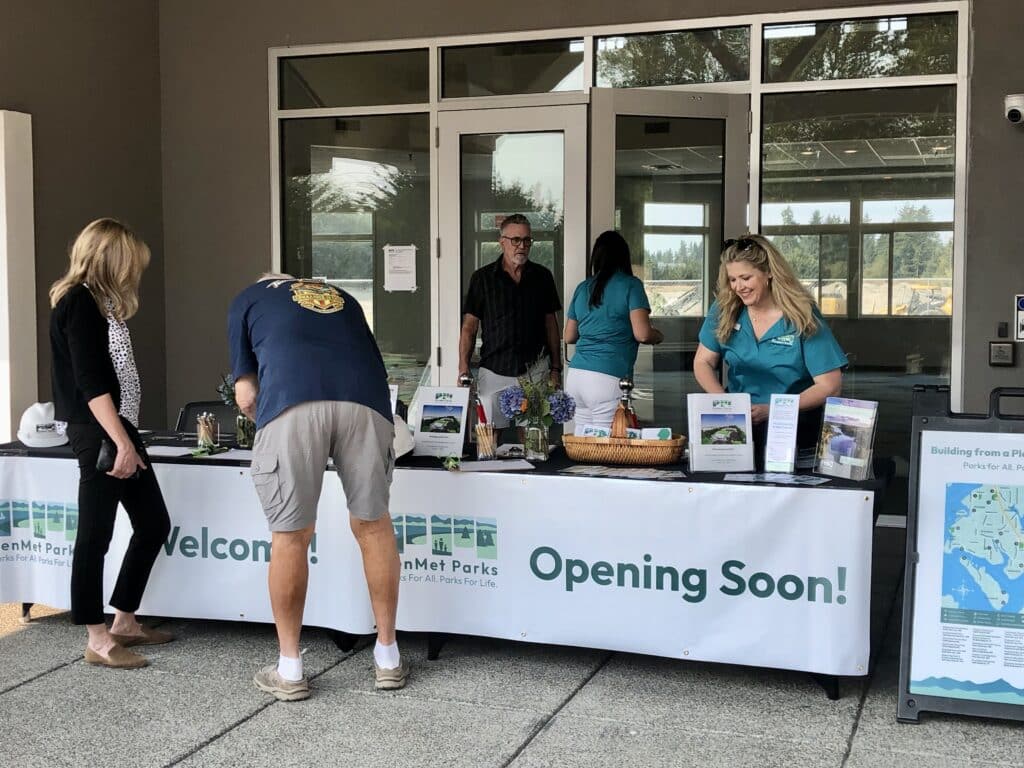 PenMet staff members at the front of the renovated community resource center welcome guests to last month's groundbreaking for Phase 2.