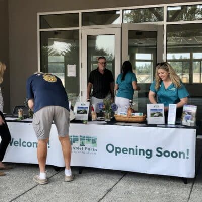 PenMet staff members at the front of the renovated community resource center welcome guests to last month's groundbreaking for Phase 2.