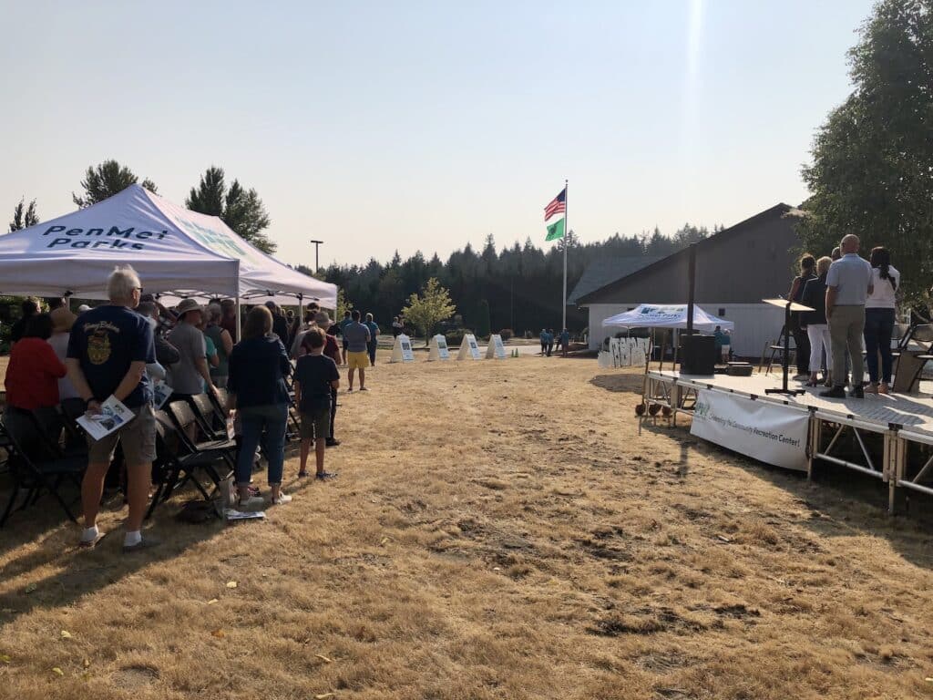 Flags are raised in front of Phase 1 during a groundbreaking last month for Phase 2.