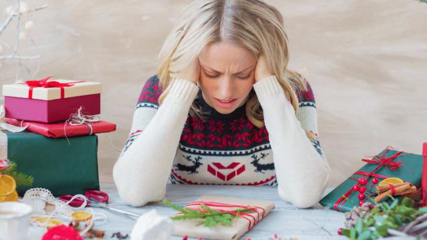 A stressed woman with her head in her hands