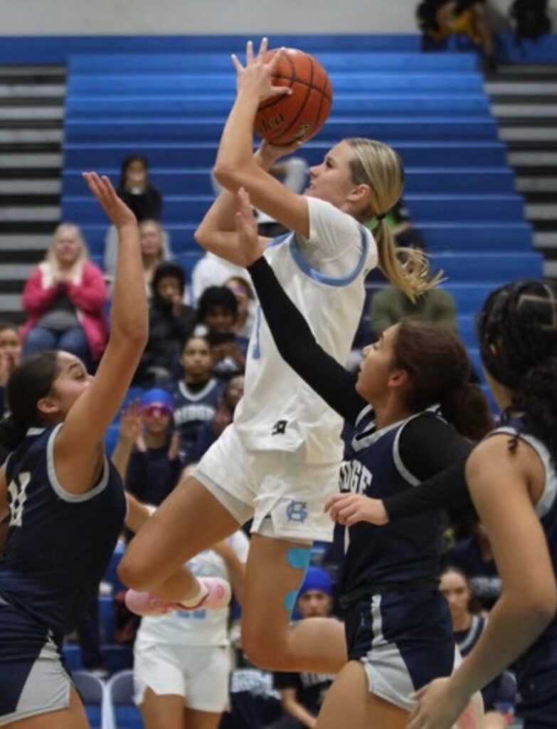 Tides leading scorer Taylor Schwab goes to the hoop against River Ridge.