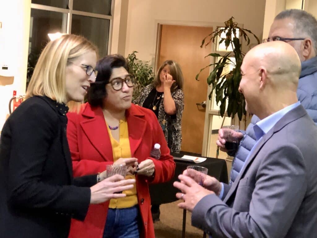 Sen. Emily Randall speaks with constituents before the legislative sendoff Wednesday.