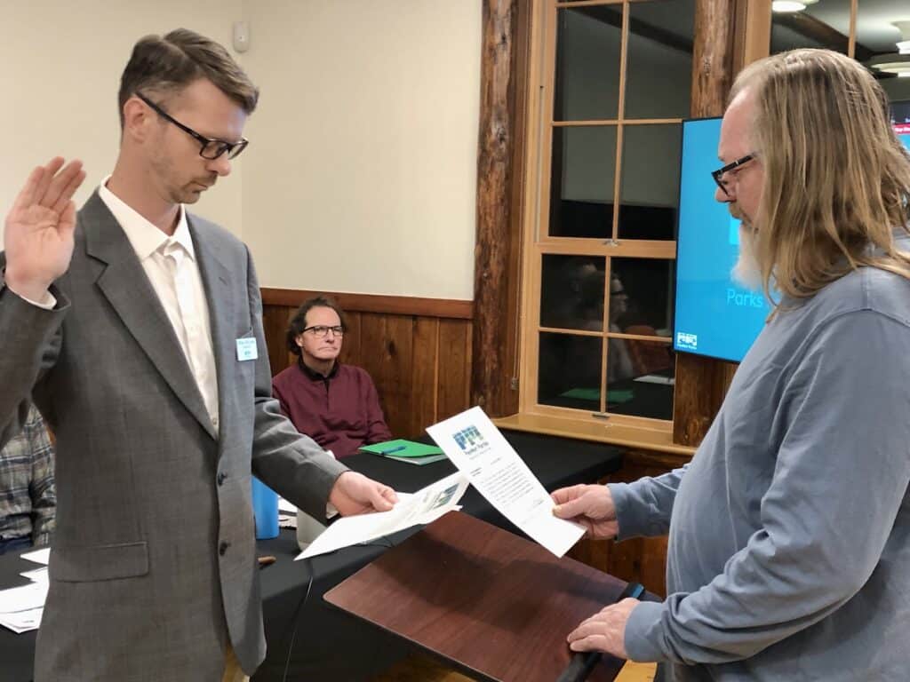 Bill Sehmel Sr. swears in son Billy as parks commissioner.