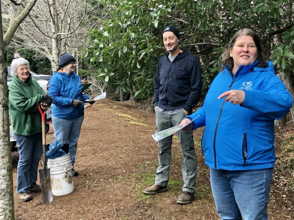 City Parks Manager Jennifer Haro directs the group on where it can dig while Michael Behrens waits to give tips on what to dig.