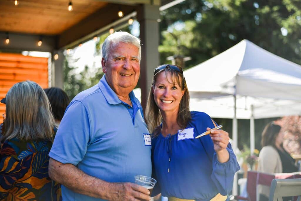 Denny Richards and County Councilwoman Robyn Denson with a wooden pencil he made for her.