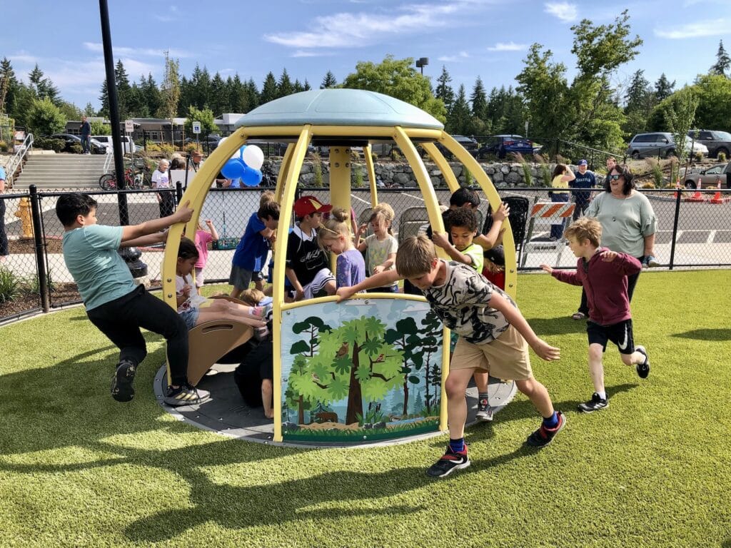 Kids play on the new playground equipment at Doris Heritage Park.