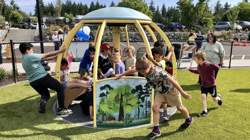 Kids play on the new playground equipment at Doris Heritage Park.